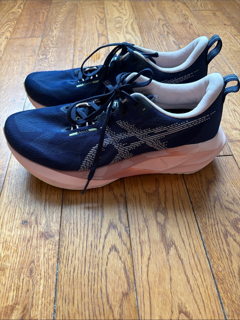 ASICS Novablast 5 running shoes in the "Midnight/Breeze" (navy/peach) colorway